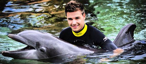 Liam Payne agarrado a un delfín en Sea World