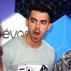 Joe Jonas abriendo la boca mientras posaba en la alfombra roja de los MTV EMA 2016