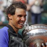 Rafa Nadal mordiendo el trofeo de campeón de Roland Garros 2017