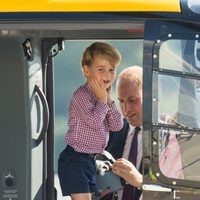 El Príncipe Jorge explorando un helicóptero en Hamburgo bajo la atenta mirada de Guillermo de Inglaterra