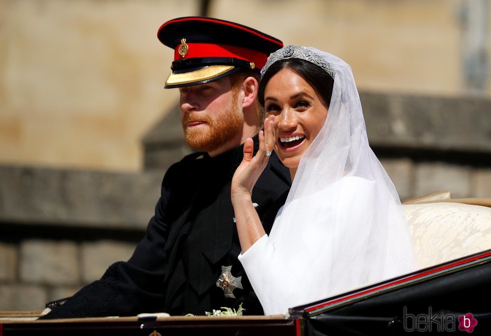 Meghan Markle saluda junto al Príncipe Harry en el carruaje tras su boda