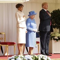 Los Trump con la mano en el corazón junto a la Reina Isabel II