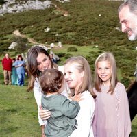 La Princesa Leonor sostiene a una niña en brazos en presencia de los Reyes Felipe y Letizia y la Infanta Sofía en Covadonga