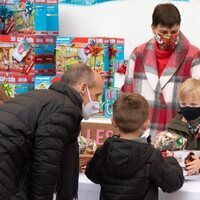 Jacques de Mónaco da regalos a un niño en presencia de Estefanía de Mónaco en la entrega de regalos navideños 2021