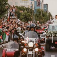 Hussein y Rajwa de Jordania saludando en la caravana roja en su boda