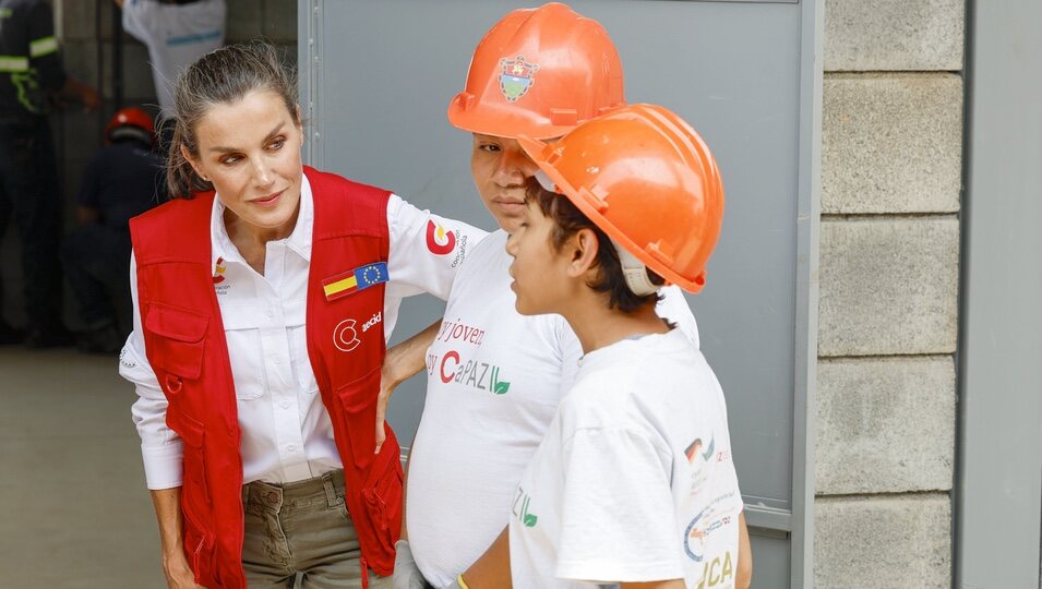 La Reina Letizia escucha a unos jóvenes que participan en la Escuela Taller Norte de Ciudad de Guatemala