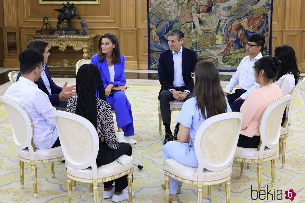 La Reina Letizia sentada con los participantes de la audiencia a una representación de la Fundación Microfinanzas BBVA