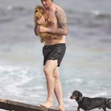 Guti sale del mar con su perro en Ibiza