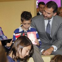 El Príncipe Felipe con unos niños durante la inauguración de la Casa del Lector