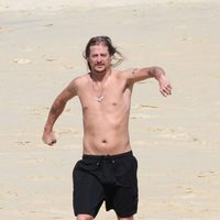 Kid Rock trota por la playa con el torso desnudo