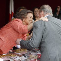 La Reina Sofía da un beso al Rey Juan Carlos en el Día de la Banderita 2014