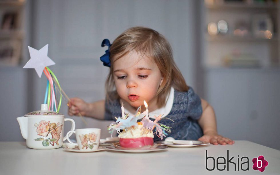 Leonor de Suecia soplando las velas de la tarta en su 2 cumpleaños